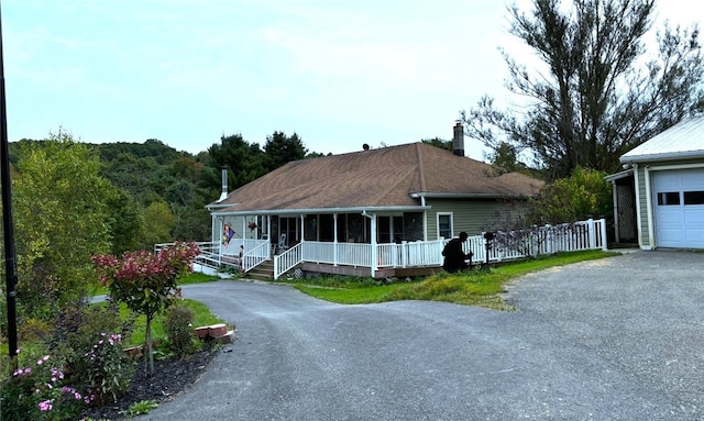 view of front facade with a porch and a garage