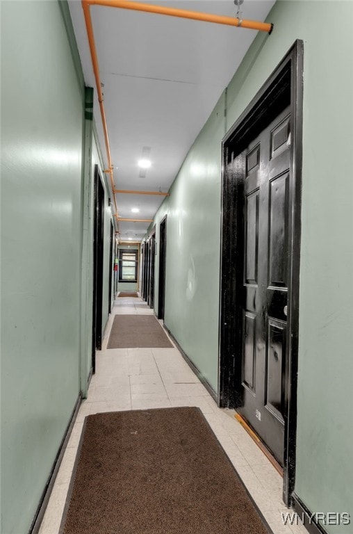 hall with light tile patterned flooring