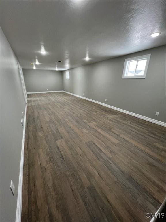 basement featuring dark hardwood / wood-style flooring