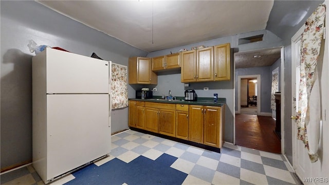 kitchen with sink and white fridge