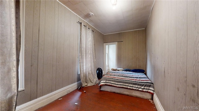 bedroom featuring wood walls