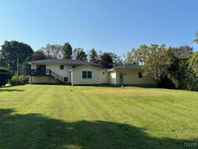 rear view of house with a lawn