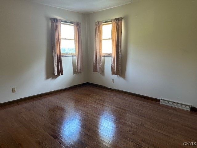 spare room with dark hardwood / wood-style flooring