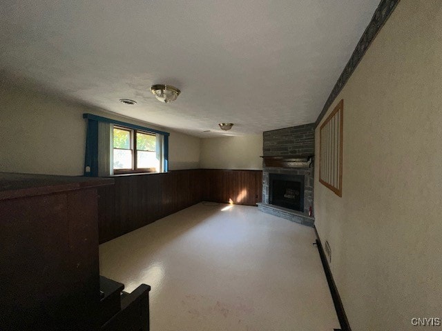 unfurnished living room with a textured ceiling and a fireplace