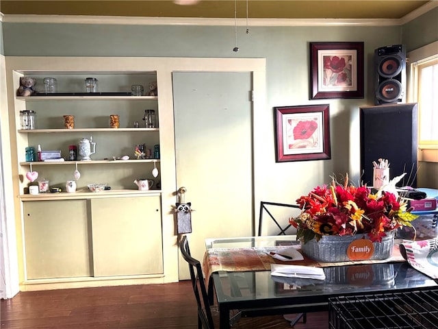 dining area with ornamental molding and dark hardwood / wood-style flooring