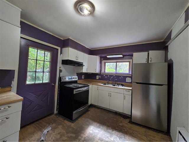 kitchen featuring white cabinets, appliances with stainless steel finishes, plenty of natural light, and sink