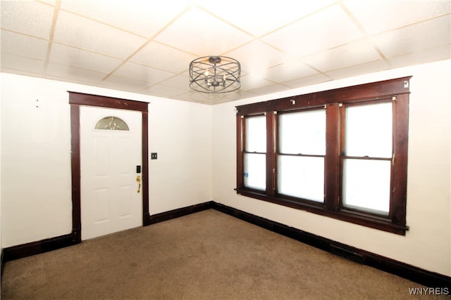 foyer entrance with light carpet and a paneled ceiling