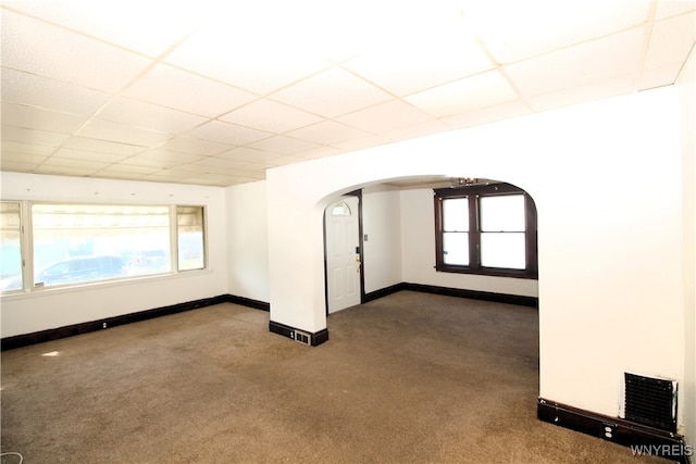 carpeted spare room with plenty of natural light and a paneled ceiling