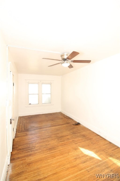 unfurnished room with wood-type flooring and ceiling fan