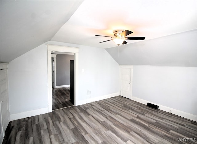 additional living space with lofted ceiling, dark hardwood / wood-style flooring, and ceiling fan