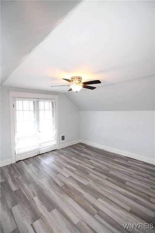 bonus room featuring ceiling fan, hardwood / wood-style flooring, and vaulted ceiling