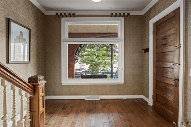 foyer entrance featuring crown molding and dark hardwood / wood-style floors