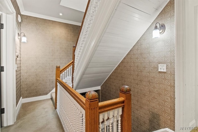 stairs featuring ornamental molding, lofted ceiling, and carpet floors