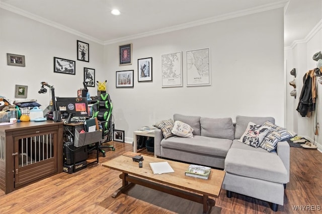 living room with light wood-type flooring and crown molding