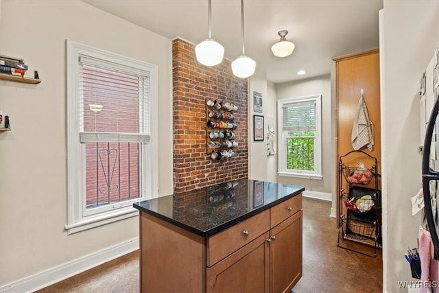 kitchen with dark stone countertops and hanging light fixtures