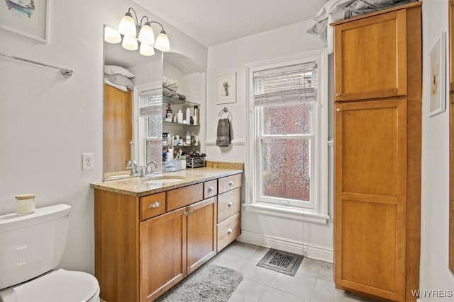 bathroom featuring tile patterned flooring, vanity, and toilet