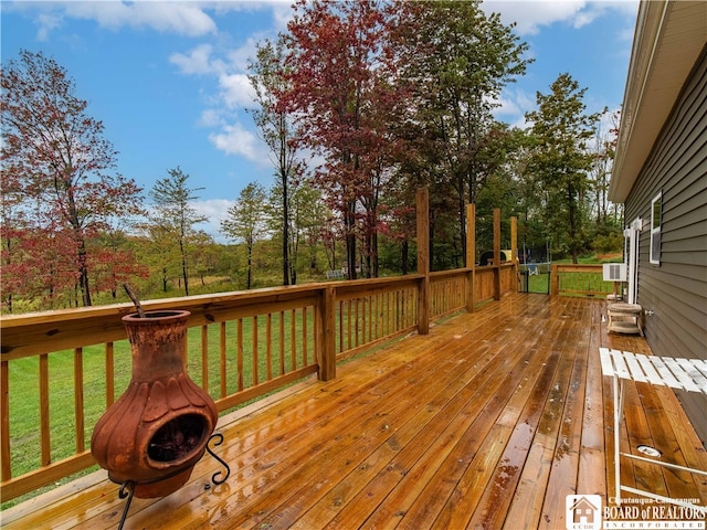 wooden deck featuring a lawn