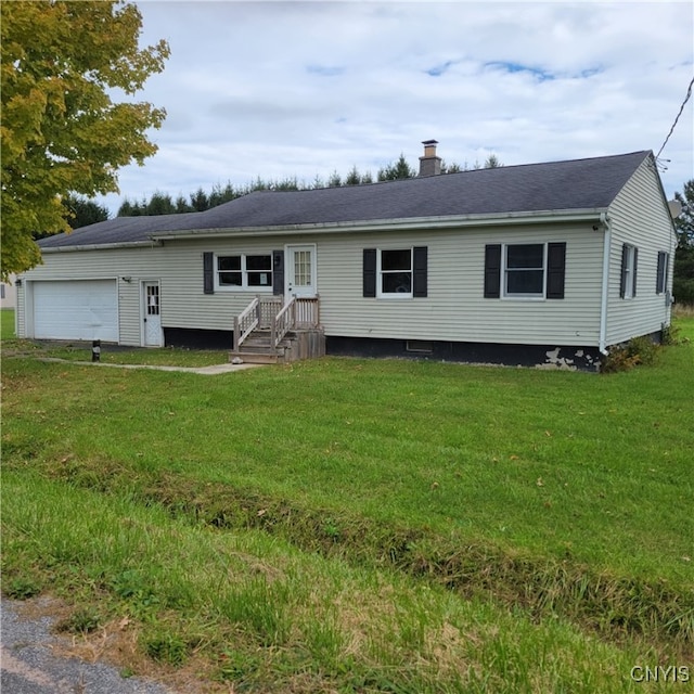 view of front of home featuring a garage and a front yard