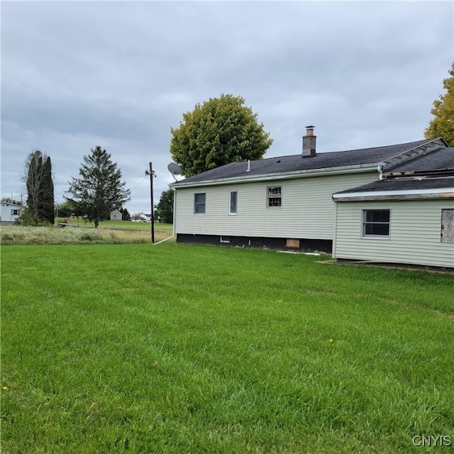 rear view of property featuring a yard