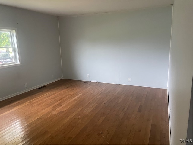 unfurnished room with hardwood / wood-style flooring