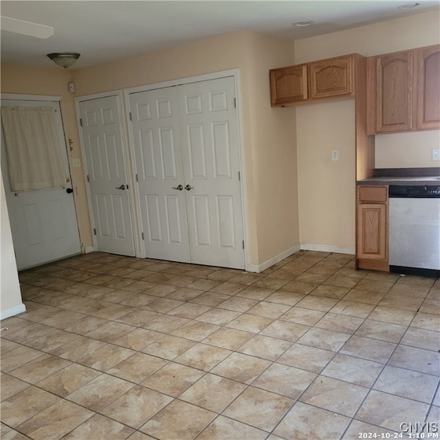 kitchen with dishwasher, light brown cabinets, and light tile patterned flooring