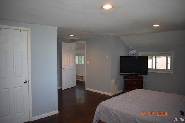 bedroom with lofted ceiling and dark hardwood / wood-style floors