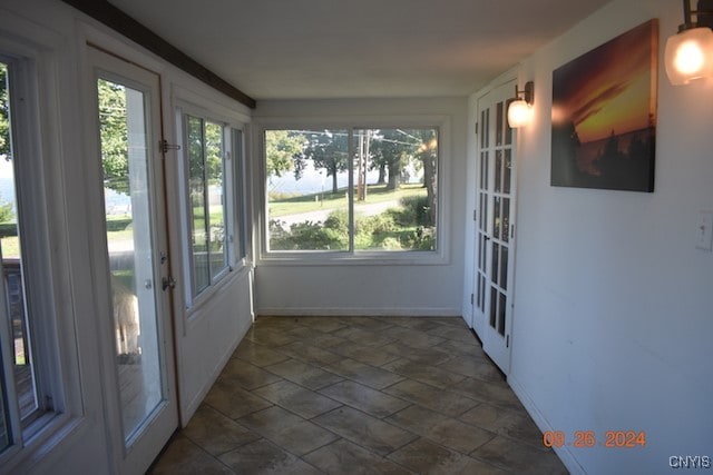 unfurnished sunroom featuring plenty of natural light