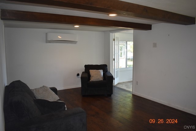 living room featuring an AC wall unit, beamed ceiling, and dark hardwood / wood-style flooring