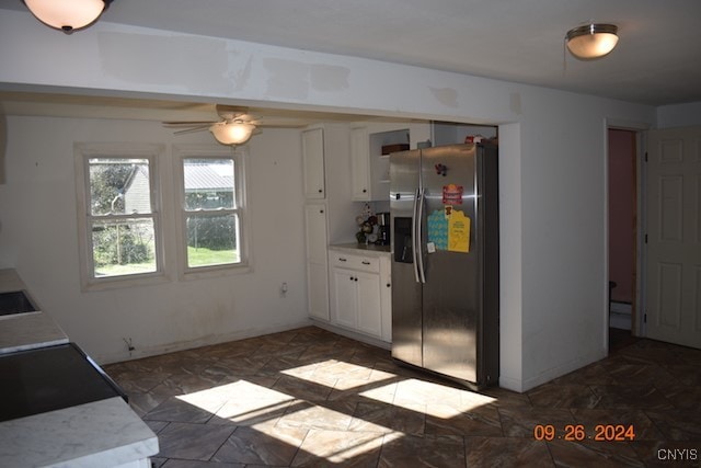 kitchen with stainless steel fridge, ceiling fan, and white cabinets