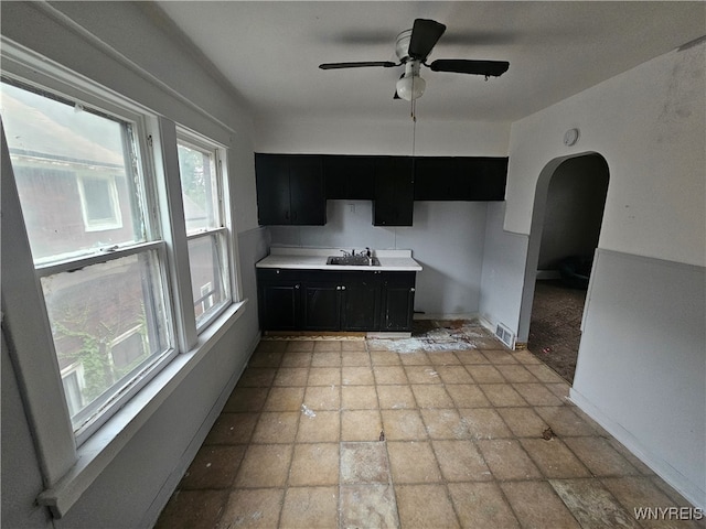 kitchen featuring ceiling fan and sink