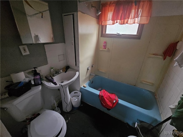 bathroom featuring tile walls and toilet