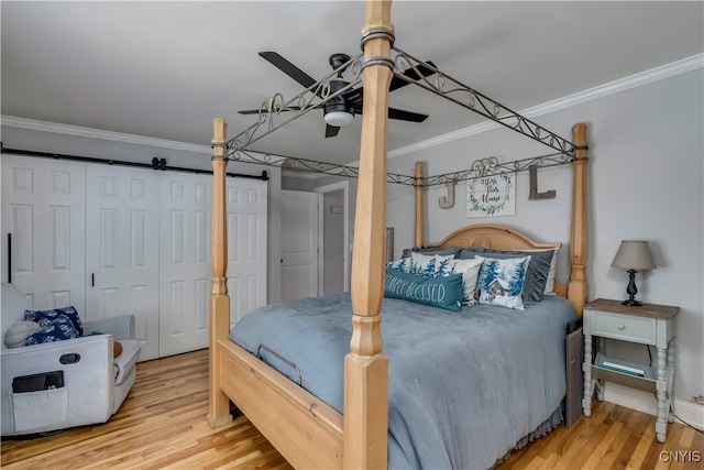 bedroom featuring ceiling fan, ornamental molding, and hardwood / wood-style floors