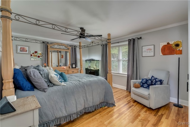 bedroom with ornamental molding, ceiling fan, and hardwood / wood-style flooring