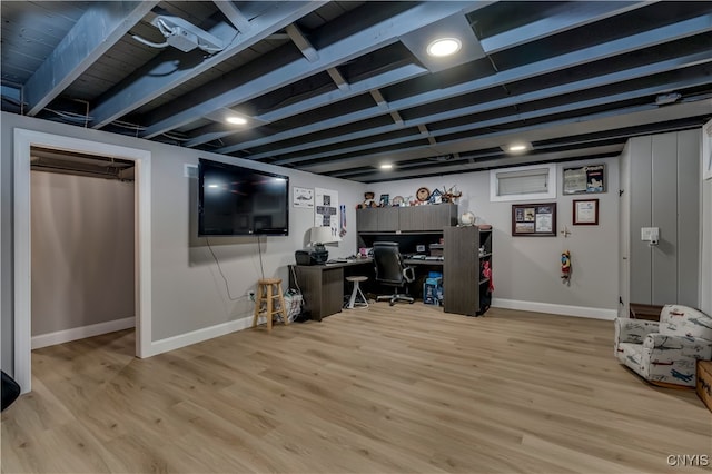 basement with light hardwood / wood-style floors