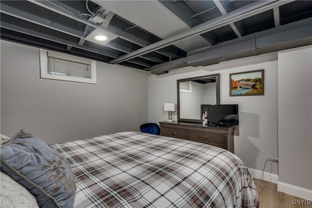 bedroom with hardwood / wood-style floors