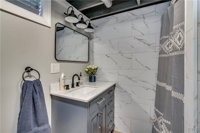 bathroom with walk in shower and vanity