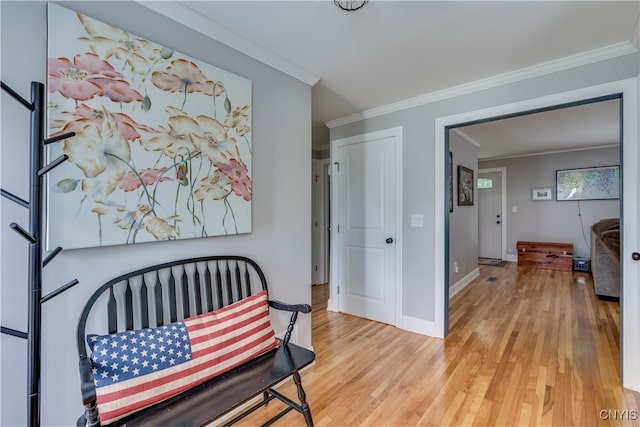 interior space with light hardwood / wood-style flooring and ornamental molding