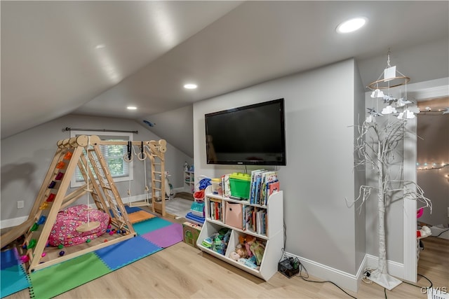 rec room with vaulted ceiling and hardwood / wood-style flooring