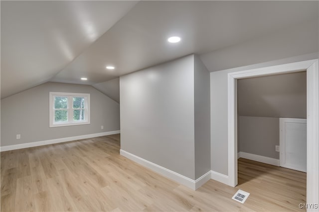 bonus room with light hardwood / wood-style flooring and vaulted ceiling