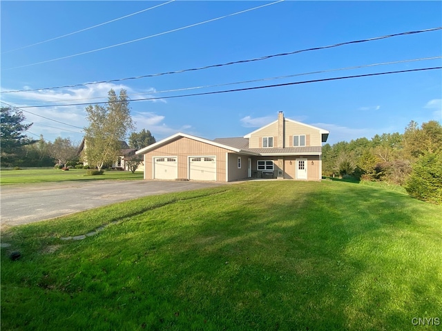 view of front of house with a garage and a front yard