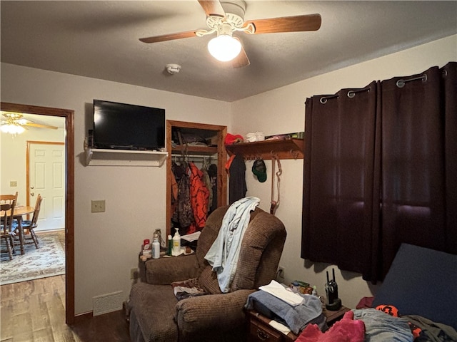 bedroom featuring ceiling fan, a closet, and hardwood / wood-style flooring