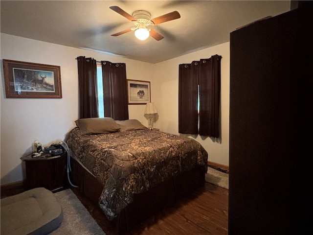 bedroom with ceiling fan and dark hardwood / wood-style floors