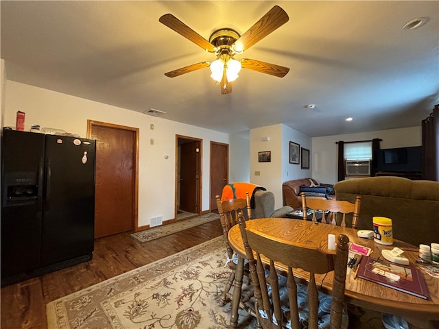 dining room featuring ceiling fan and dark wood-type flooring