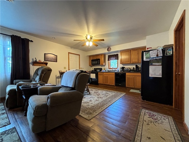 living room featuring ceiling fan, dark hardwood / wood-style floors, and sink