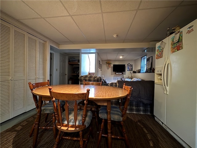 dining area featuring a drop ceiling