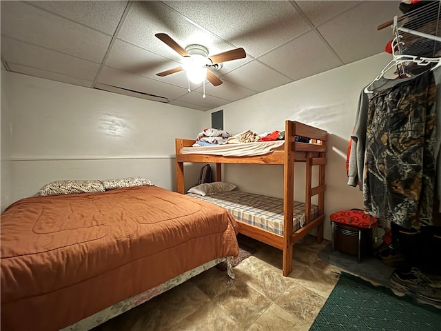 bedroom featuring ceiling fan and a paneled ceiling