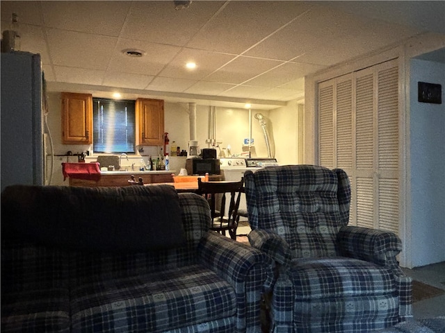 interior space featuring sink and a paneled ceiling