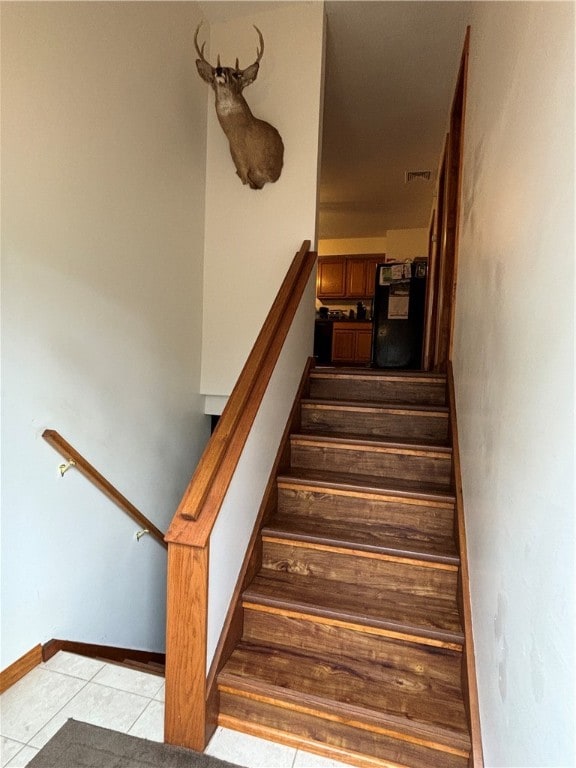 stairs featuring tile patterned floors