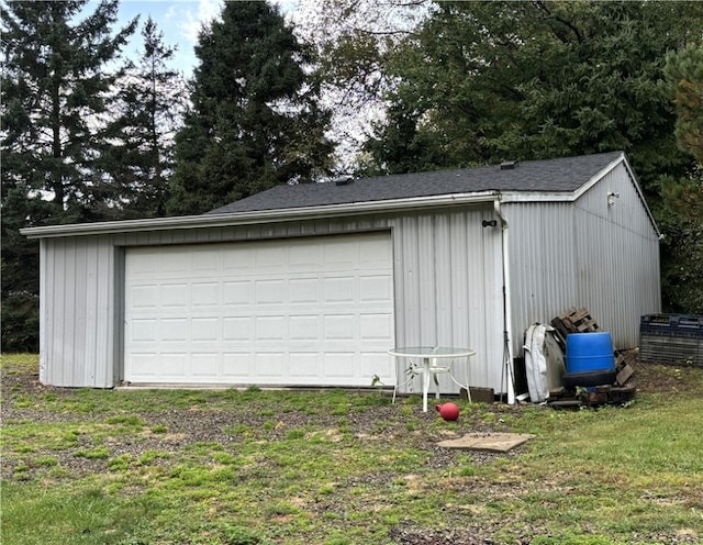 garage featuring a lawn