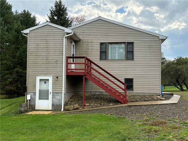 back of property featuring a yard and a deck